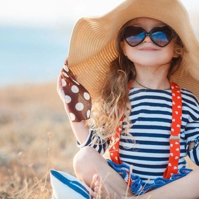 kid wearing hat and sunglasses